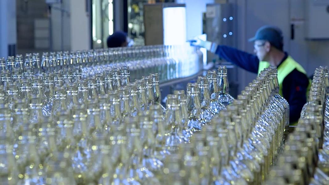 Rows of clear glass bottles